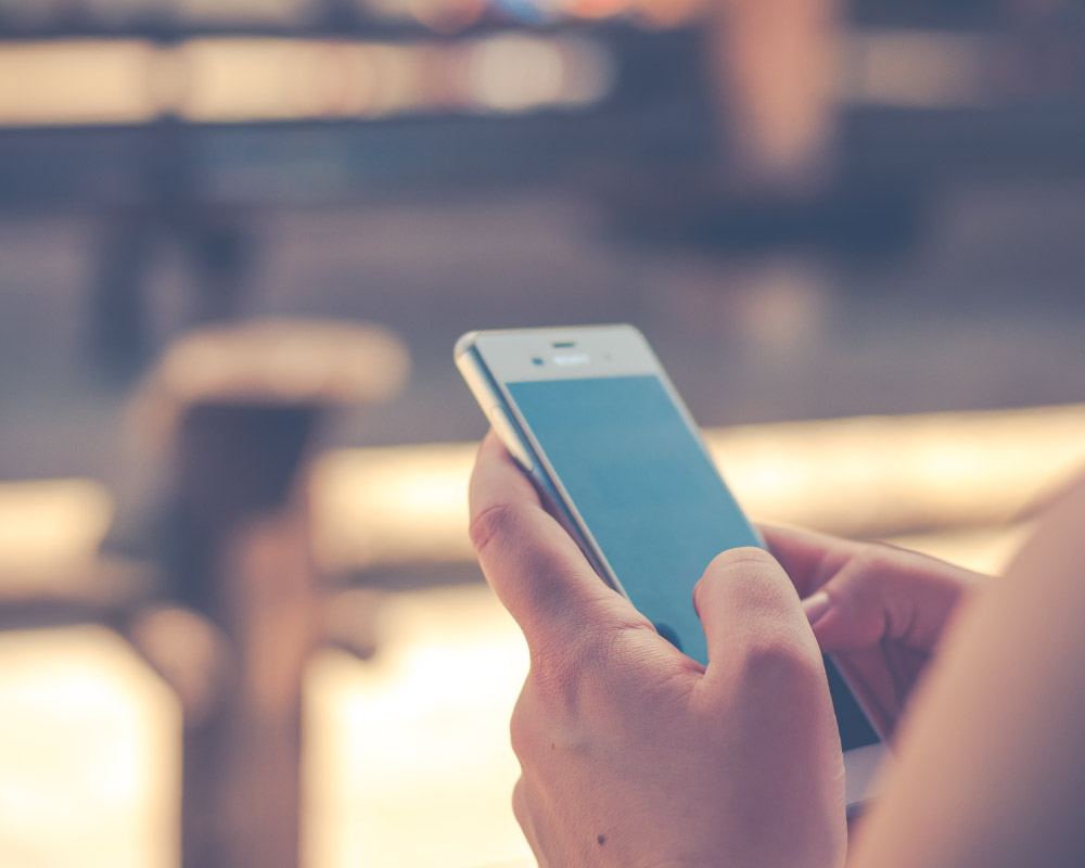 hands holding smartphone to search for dentist in college station