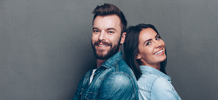 Couple smiling with dark background