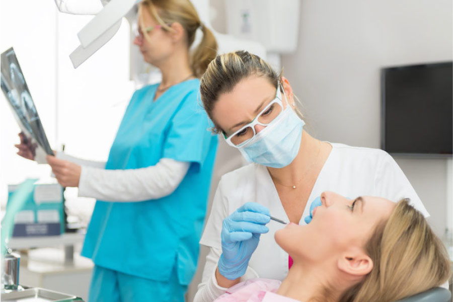 woman at the dentist getting a tooth restoration 