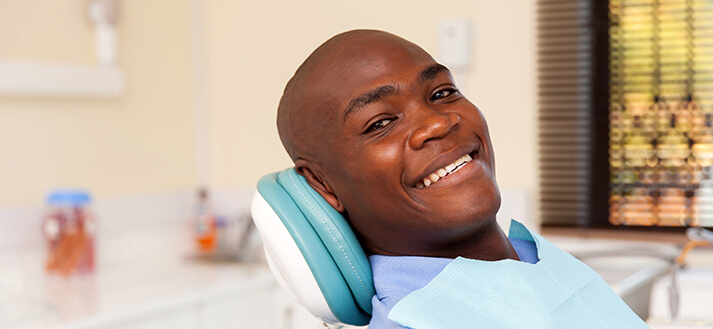 smiling man sitting in a dental chair